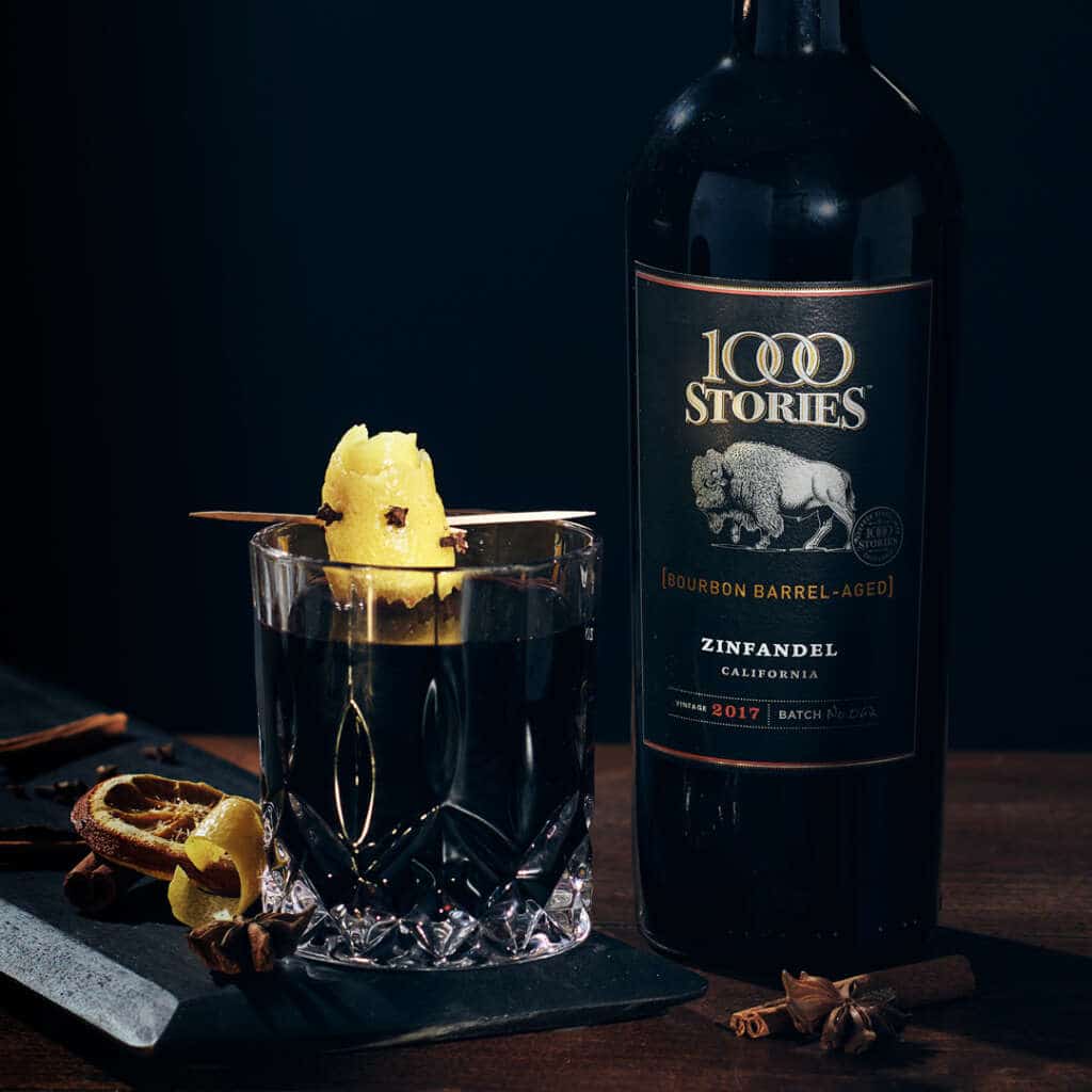 1000 Stories Zifandel bottle next to glass of Smoking Bishop cocktail